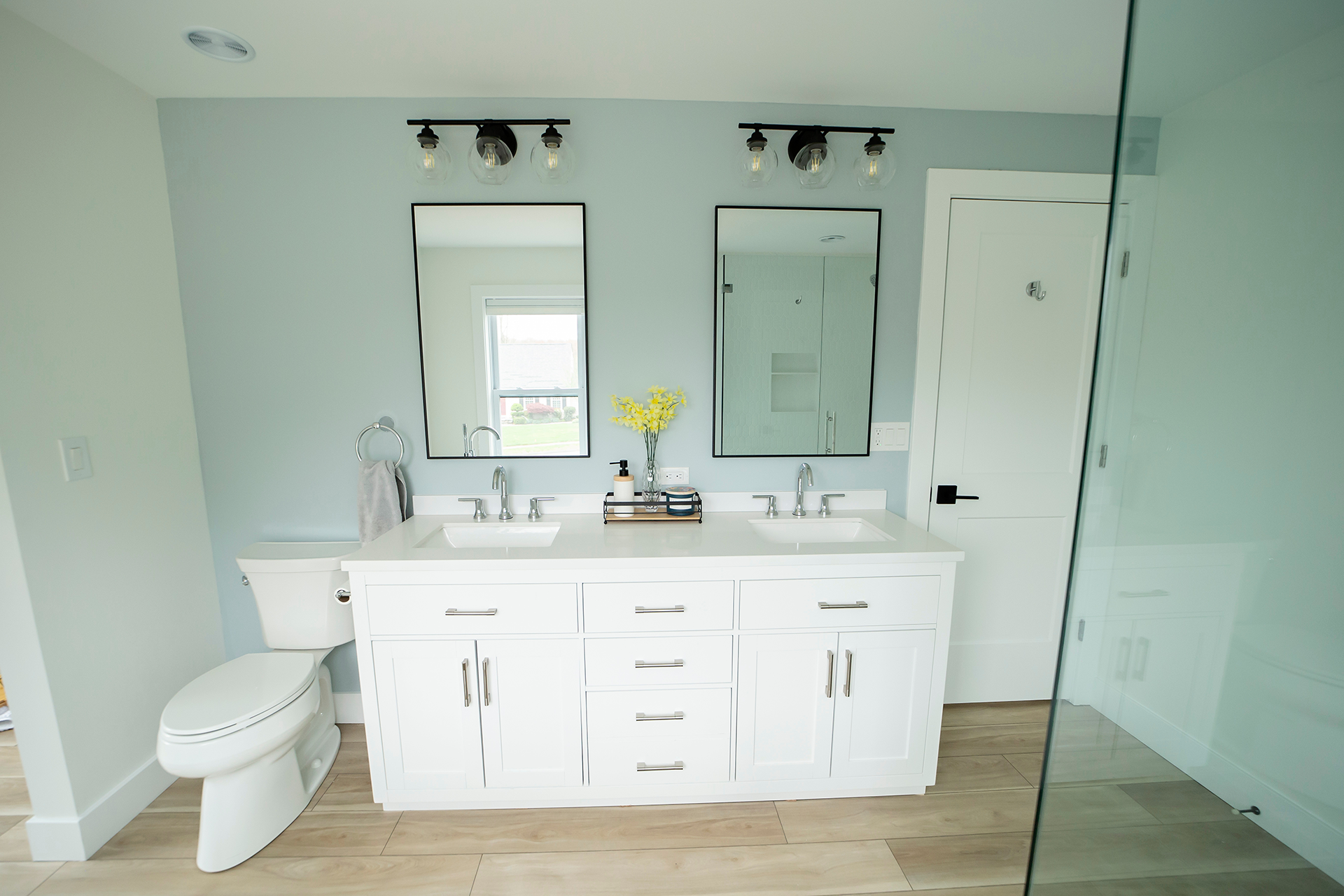 Custom dual vanity with LED lighting and modern mirrors
